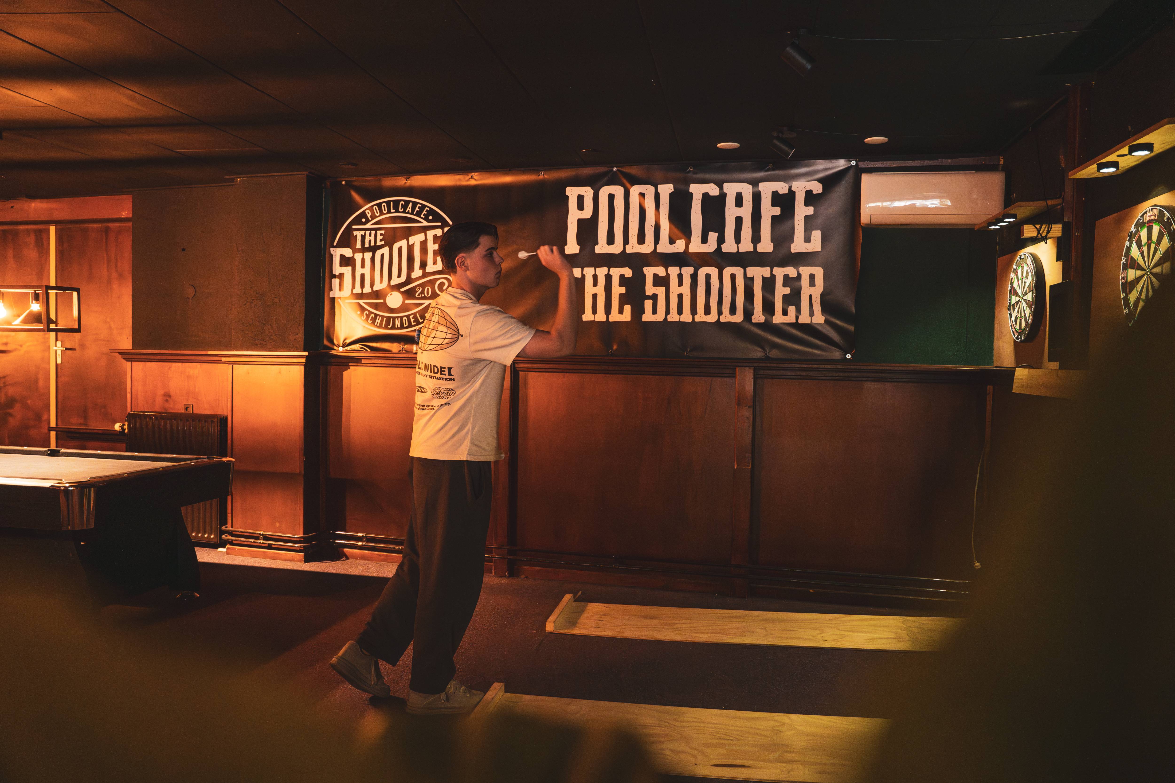 Dartspeler bij The Shooter spandoek